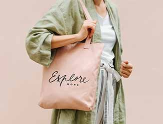 Person carrying a custom imprinted tote back outside.